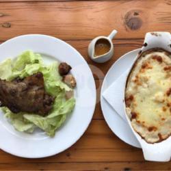 Duck Confit With Fresh Salad And Potato Gratine